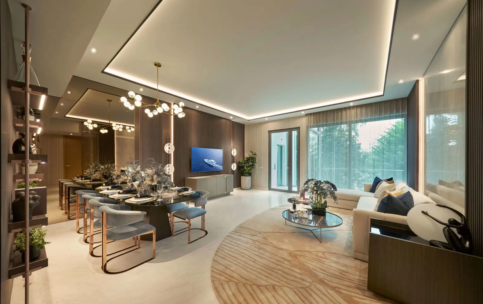 The Residences at W Sentosa Cove, photograph: a living and dining room with a dining table for eight, a round rug and a full-height window to the greenery outside